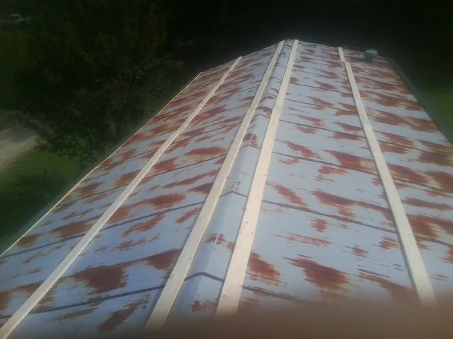 Rusted metal roof panels with new wood purlins before replacement — Storm Damage Roof Repair in Redwood City by Roofing Brothers